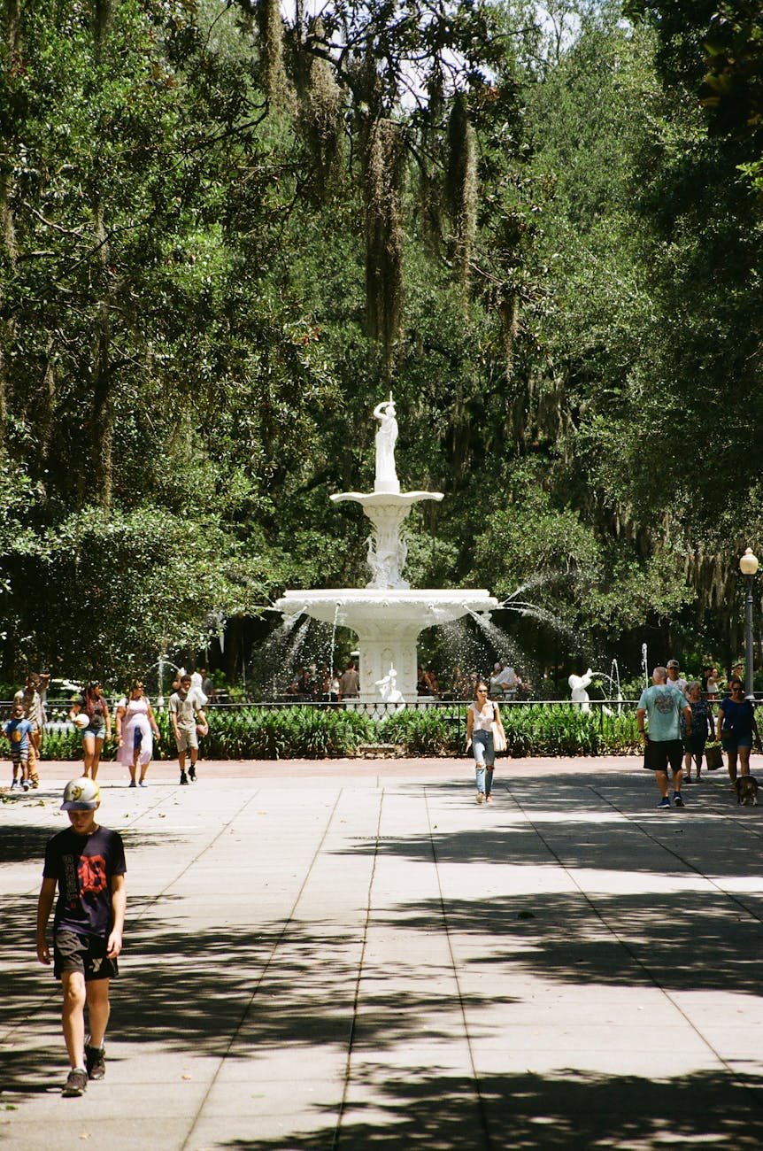 People Walking on the park near the Forsyth Park fountain.